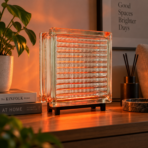 Clear glass block lamp with warm orange ambient light